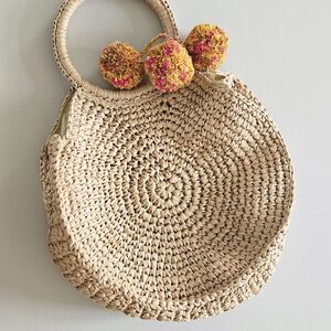 Chic Tan Woven Clutch with Pom Poms